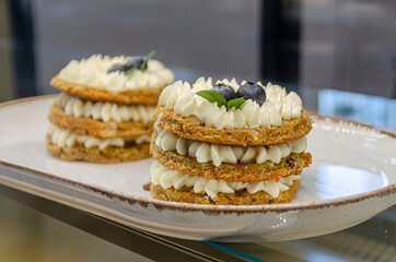 creamy biscuits. cookies in three layers with a cream layer and blueberries with mint High quality photo