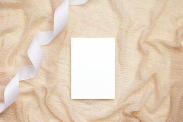 Fototapeta premium 5x7 card mockup on beige background with ribbon