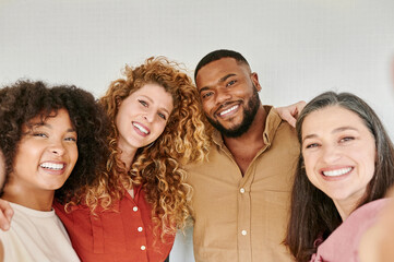 Diverse friends smiling and taking selfies
