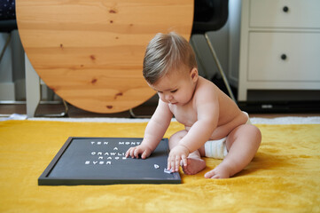 Baby playing with letters on board