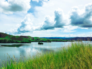 beautiful scenery in highlands. a lake among the mountains. greenish background as a fresh, joyful, fair, clear and calm weather in meadow.