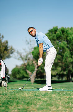 Man playing golf on summer day