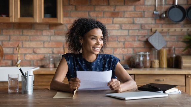 Ambitious Young Biracial Woman Get Loan Approval Paper Letter From Bank Dream Of New Opportunity. Happy Black Female Small Business Owner Receive Good News By Mail In Financial Report Think Of Profit