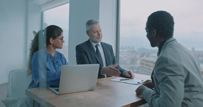 African businessman shake hands with recruiters and leave the room