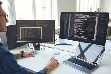 IT Programmer Writing Code on Computer Screen - obrazy, fototapety, plakaty