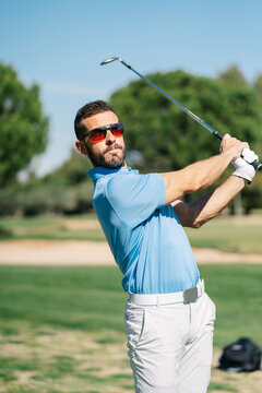 Man playing golf on summer day