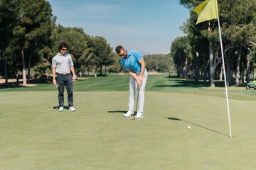 Adult men playing golf together