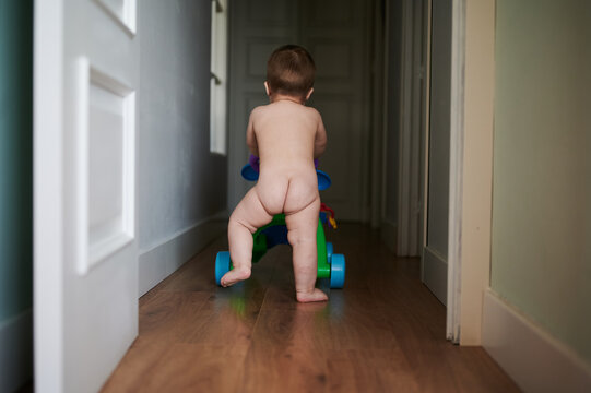Naked toddler in hallway