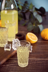 Italian drink lemon liqueur limoncello in glasses on the wooden table