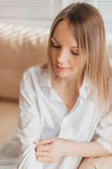 Naklejka premium Fashion portrait of a young beautiful blonde woman indoor in studio