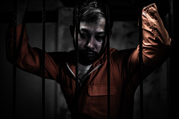 Asian man desperate at the iron prison,prisoner concept,thailand people,Hope to be free,Serious prisoners imprisoned in the prison