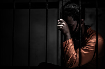 Asian man desperate at the iron prison,prisoner concept,thailand people,Hope to be free,Serious...