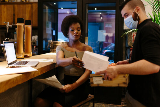 Restaurant manager signing dispatch note.
