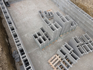 Aerial drone photo of a construction site for a pool, concrete blocks already coated and bricked up...