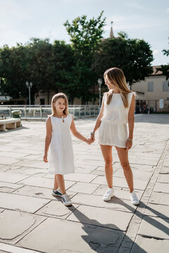 Mother and daughter walking outdoor in summer