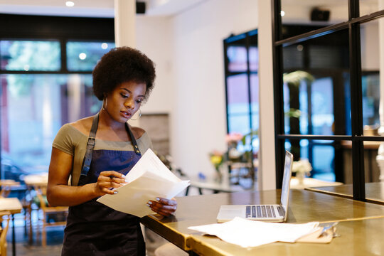 Restaurant manager checking business documents