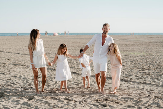 A happy family consisting of five people at the beach