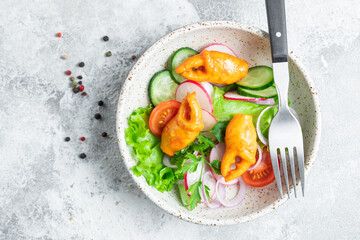 salad seafood vegetable crab claws, surimi crab sticks tomato, cucumber, lettuce on the table meal snack copy space food background rustic 
