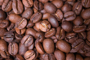 close up of Freshly roasted coffee beans background. top view