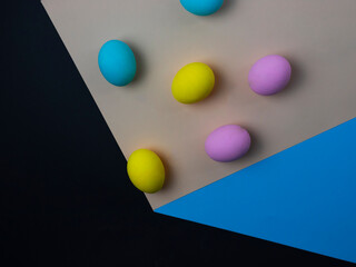 painted eggs falling down, paper cube optical illusion, easter concept, copy space