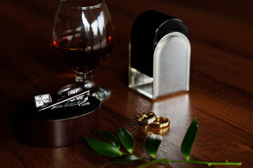 Details from the groom. Whiskey, rings, cufflinks, perfume
