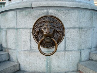 Mascaron in the form of a lion's head with a ring on a stair street crossing