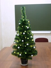 Decorative Christmas tree on the table in the classroom