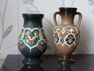 A jug and a vase painted with a multi-colored complex pattern