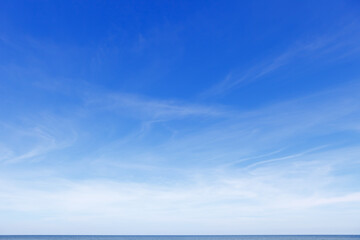 Naklejka na ściany i meble Beautiful blue sky over the sea with translucent, white, Cirrus clouds