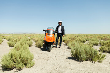 Man Driving a scooter in the desert