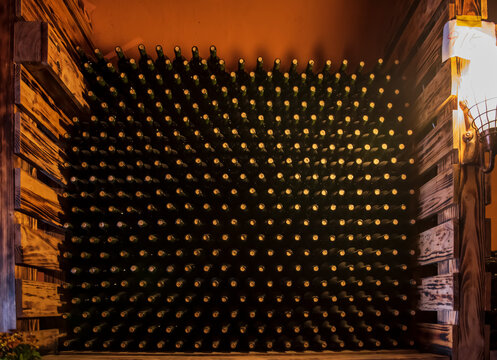 Wine bottles in wine cellar, row of glass bottles