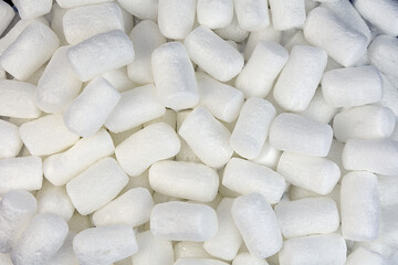 Fototapeta na wymiar background of small white polystyrene foam cylinders