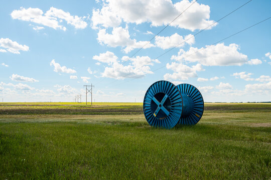 large blue cable reels on grassland