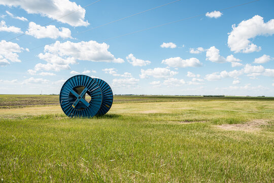 large blue cable reels on grassland