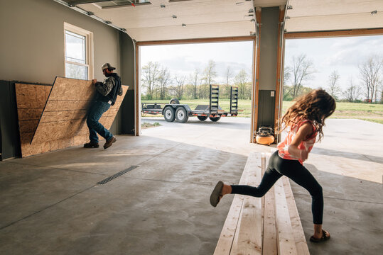 Man working in garage with girl.