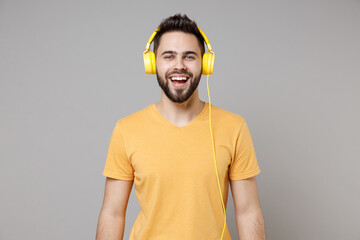 Young caucasian smiling bearded attractive handsome student happy man 20s wearing casual yellow...