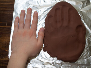 a cast of the boy's hand on polymer clay. a moment to remember