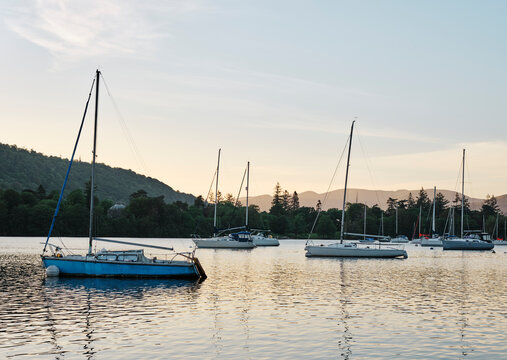 Sailing boats on Lake Windermere at sunset. Ferry Nab, Lake District, Cumbria, UK.