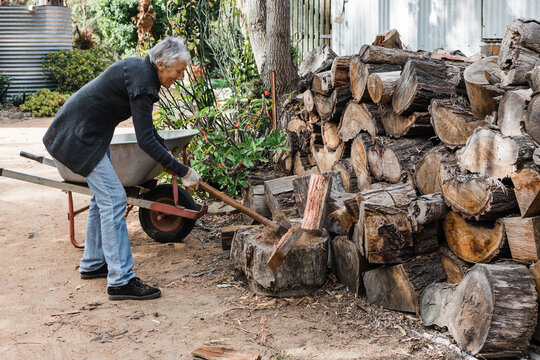 Woman splitting firewood