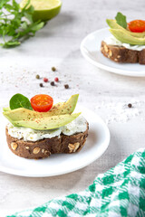 Avocado toast on light base. Vertical format.