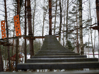 rope town. a wooden staircase between the trees. steps up