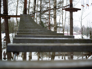 rope town. a wooden staircase between the trees. steps up