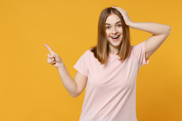 Young surprised wondered happy woman 20s with nude make up wearing casual basic pastel pink t-shirt...