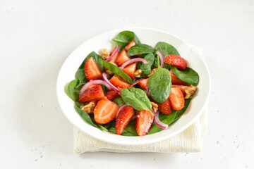 Healthy breakfast with fruit salad from strawberry, spinach and walnut