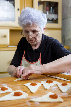 Senior woman baking sweets at home