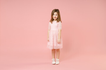 Full length little cute kid girl 5-6 years old wears rosy dress have fun standing isolated on...
