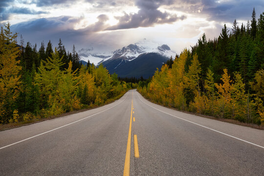 Scenic road in the Canadian Rockies during a vibrant sunny and cloudy summer morning. Dramatic Sky Artistic Render. Taken in Icefields Parkway, Banff National Park, Alberta, Canada.