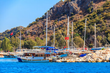 Fototapeta na wymiar Port with tourist boats on the Mediterranean sea coast in Turkey