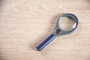 Magnifying glass with the wooden table bakcground