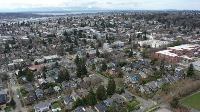 Cinematic aerial trucking drone footage of West Woodland, Fremont, Wallingford, Freemont, Meridian, Phinney Ridge, Ballard, Adams, residential Seattle neighborhoods near downtown Seattle, Washington
